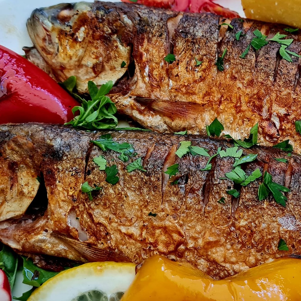 Scrumbie la grătar cu mămăligă, lămâie și ardei coacere, servită la BONFISH Constanța